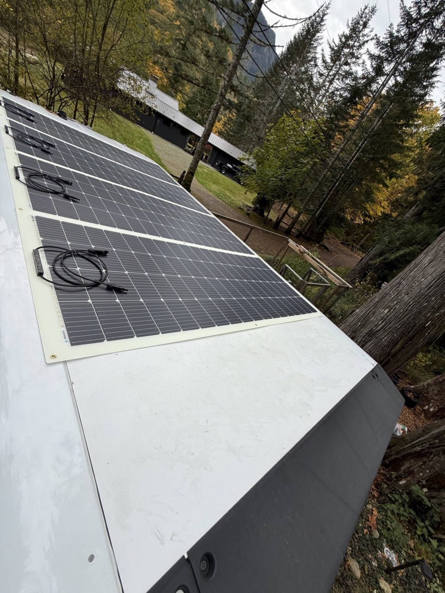Row of flexible solar panels bonded to a BrightDrop van roof